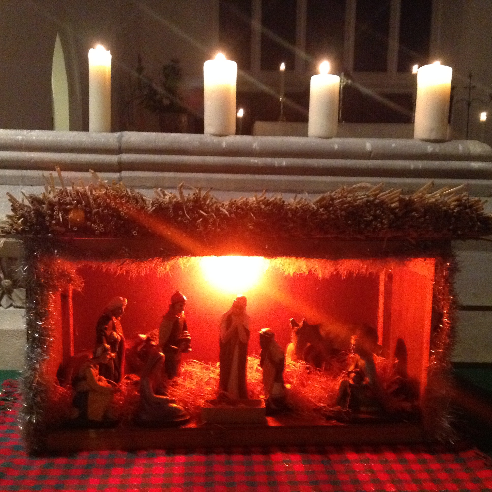 The nativity stable lit with candles